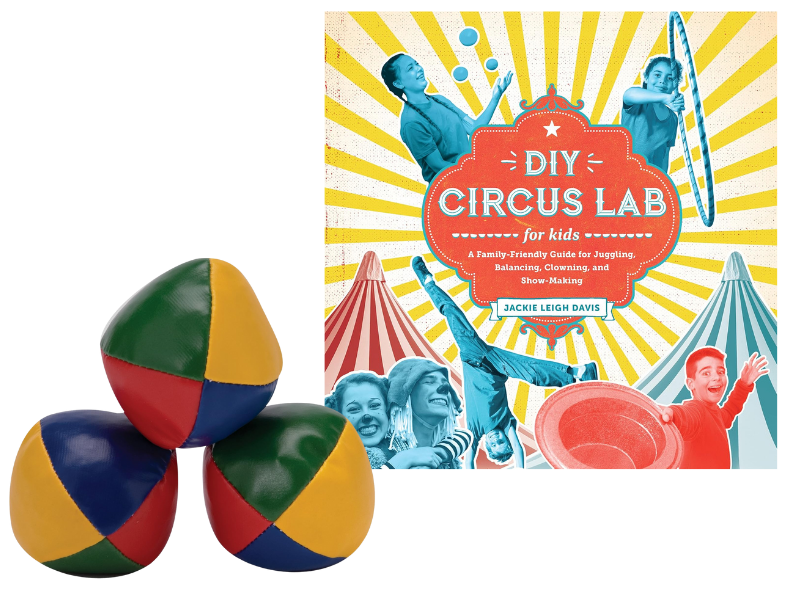 three juggling balls and the book "DIY Circus Lab"