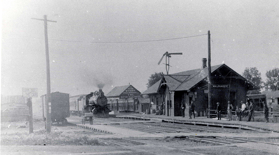 Black and white historical photo of the Waunakee Depot
