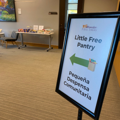 Photo of a sign with a green arrow pointing left