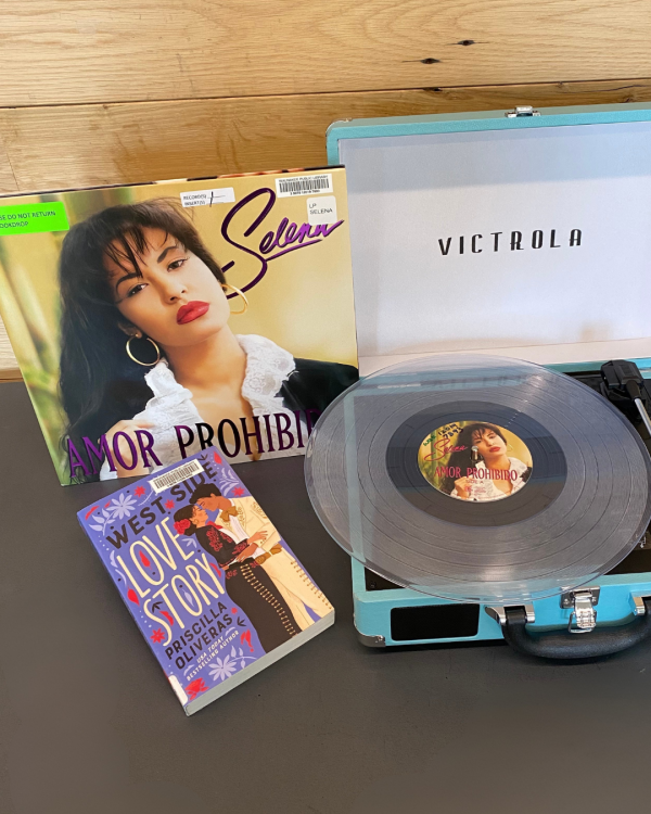Amor prohibido by Selena record next to West Side Love Story book