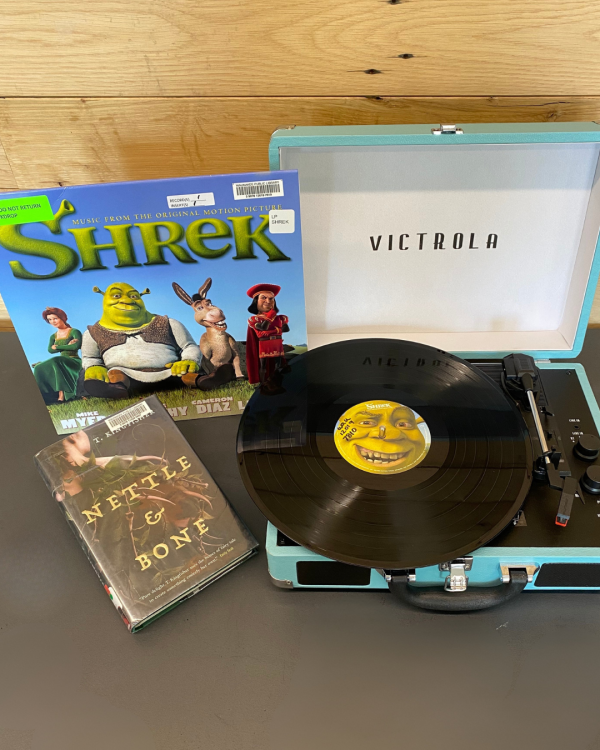 Shrek record on record player next to book Nettle and Bone