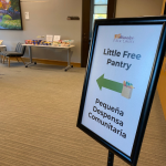 Photo of a sign with a green arrow pointing left