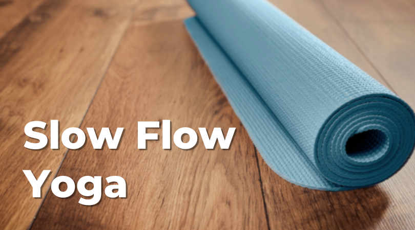 Blue yoga mat on wood floor. Slow Flow Yoga
