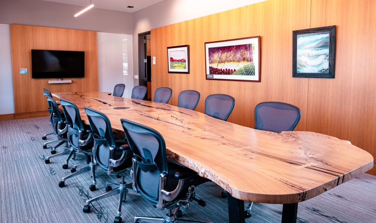 Room with a large wooden table and chairs around it