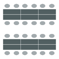 Rows of long tables with chairs on each side of the table but not at the ends. Seats 12 per table.